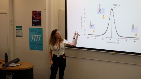 Matilda Clark, a PhD student, delivering a presentation on investigating protein thermal durability.