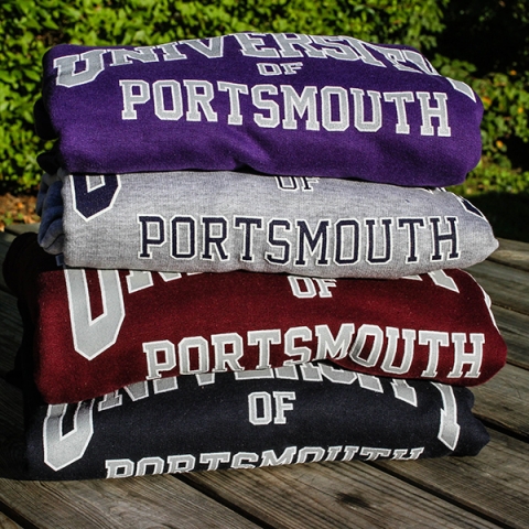 Four University of Portsmouth hoodies folded in a pile