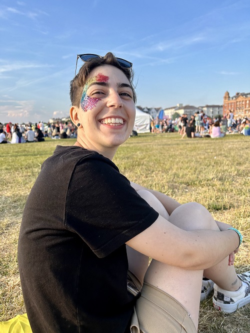 International student Marta sat on the grass at Portsmouth Pride