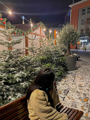 Student sitting on a bench in Gunwharf Shopping Centre