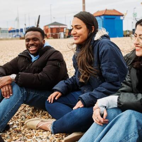 group of students chatting on the beach