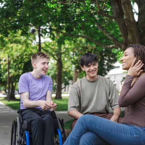 Three students laughing and talking