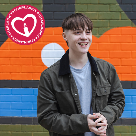 Chaplaincy teaser image showing a smiling student standing in front of a colourful wall