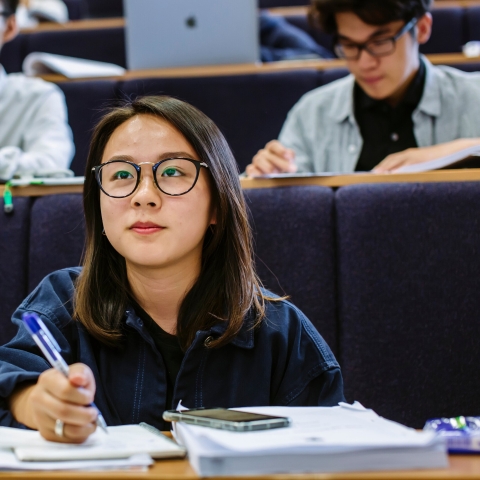 Female student taking notes in lecture