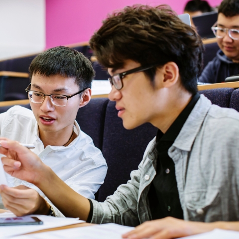 Students discussing notes in pre-sessional English session