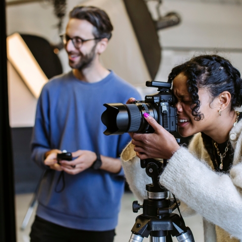 UoP student in photography studio with camera