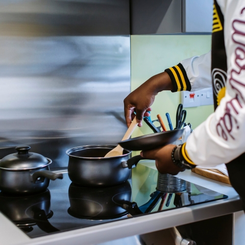 A student using a university halls kitchen