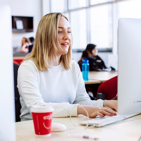 Female student using computer in Eldon suite