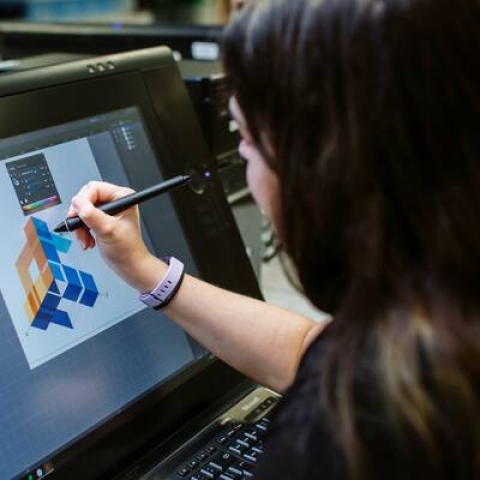 Student using stylus to design on screen
