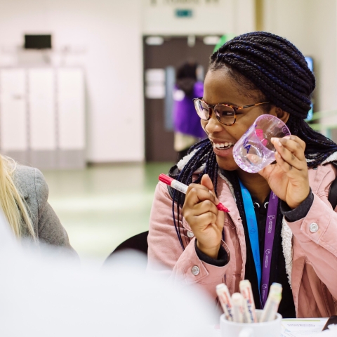 Young women painting glassware