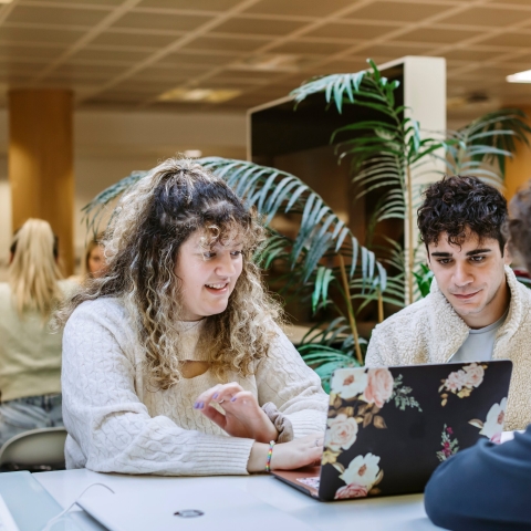Three students conversing in a study space