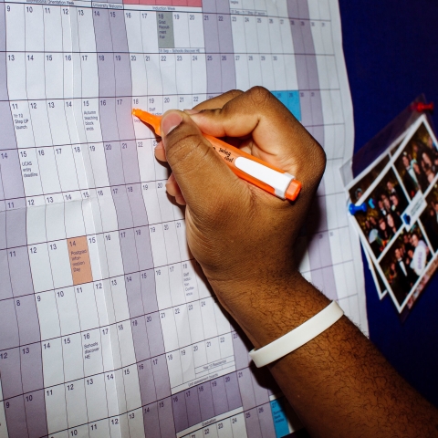 A hand writing on an academic calendar