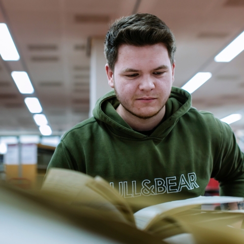 Student working on essay in library