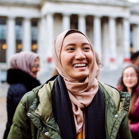 International students smiling and laughing outside Portsmouth Guildhall