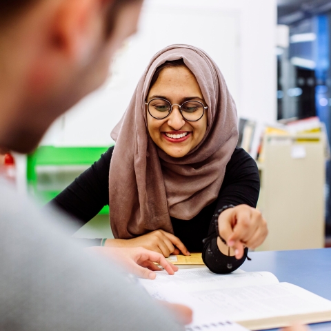 Students using text books to study