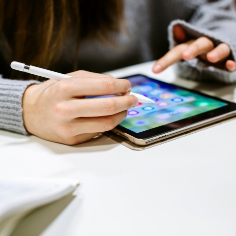 Female academic using a tablet with pencil