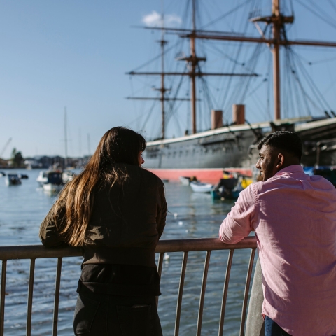 Female and male student looking towards the harbour