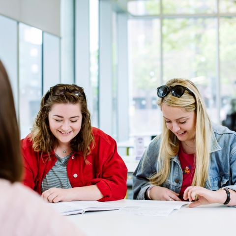 Two female students smiling and having fun