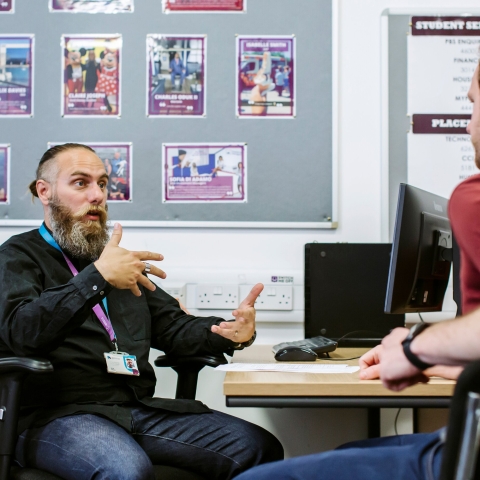 Staff discussing issues with a student