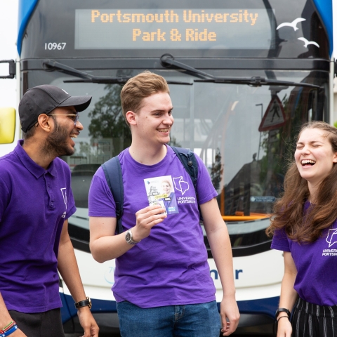 Three student ambassadors standing by Park and Ride bus - Open Day 2023