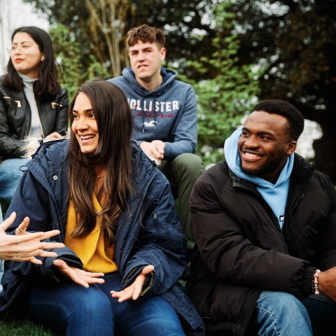 Students sat chatting in a group outside