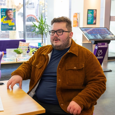 Two people sitting and talking