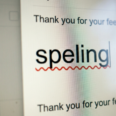 Close-up of a computer screen showing the word “speling” underlined in red with a spelling correction in progress.