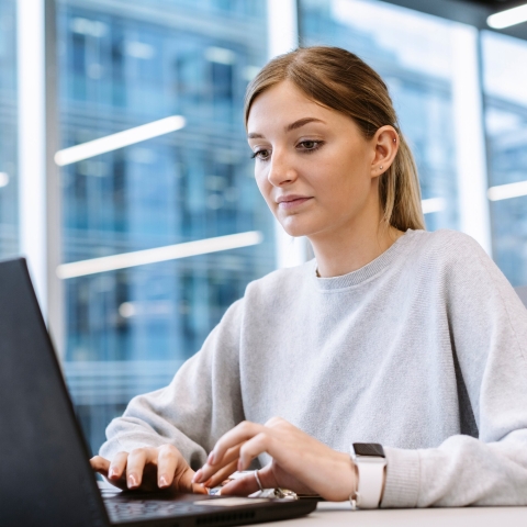 A student looking at a laptop screen.