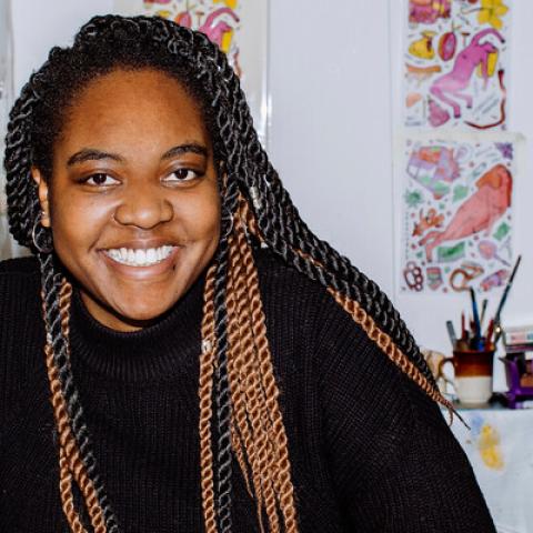 University of Portsmouth student smiling in an art studio