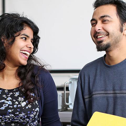 students talking and laughing together in lab