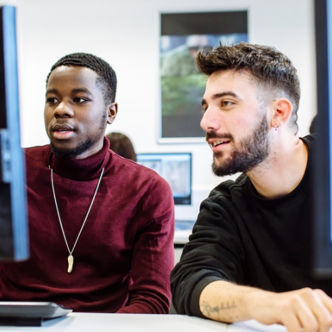 2 male students in front of computers