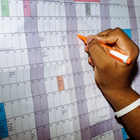 A hand writing on an academic calendar