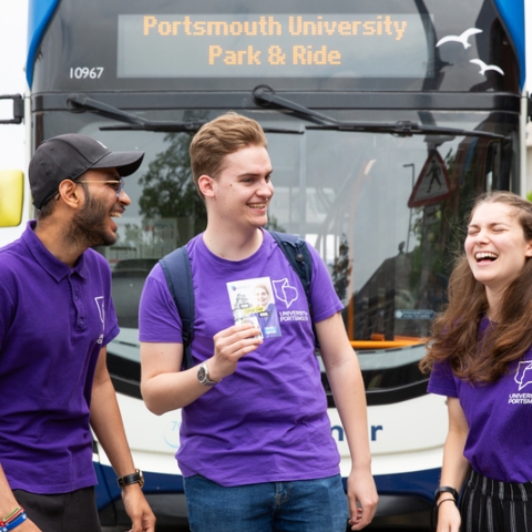 Three student ambassadors standing by Park and Ride bus - Open Day 2023