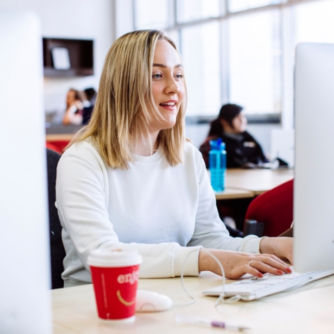 Female student using computer in Eldon suite