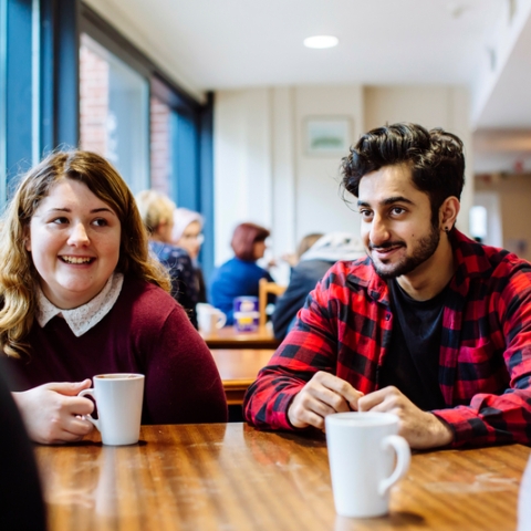 Male and female University of Portsmouth students drinking coffee
