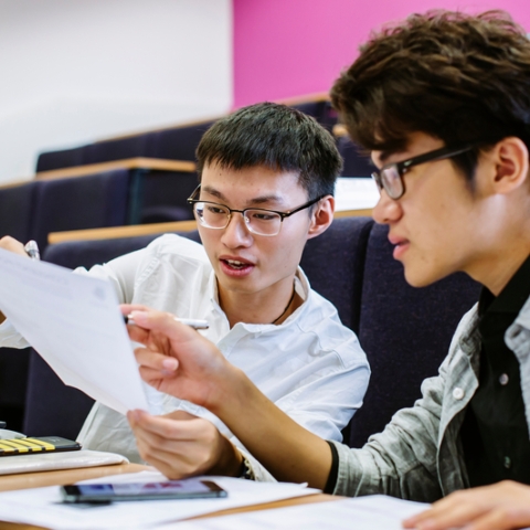 Students discussing notes in pre-sessional English session