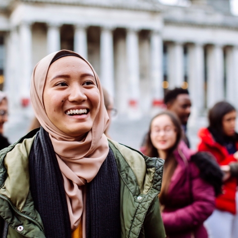 International students smiling and laughing outside Portsmouth Guildhall