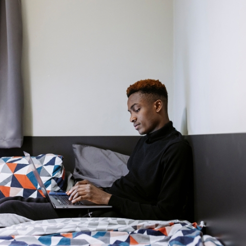 Student using their laptop from their uni accommodation