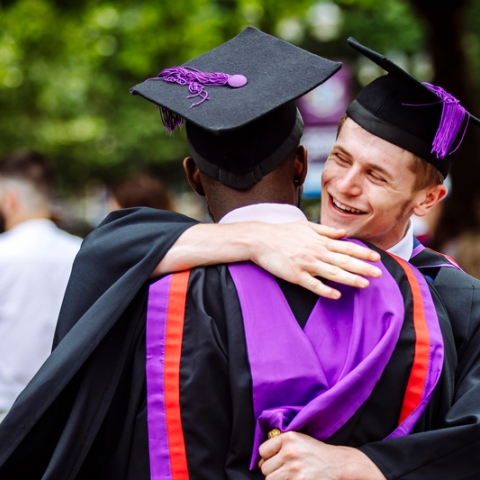 Students hugging at their graduation