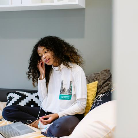 Student on bed in halls