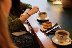 Two diners sitting with coffee and cake at table
Hideout Coffee - City Guide 2022