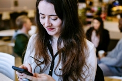 Student smiling at phone