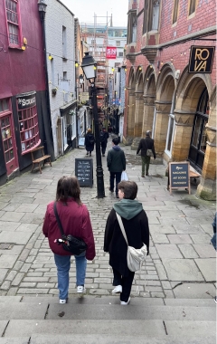 Two female students walking down a lane in Bristol