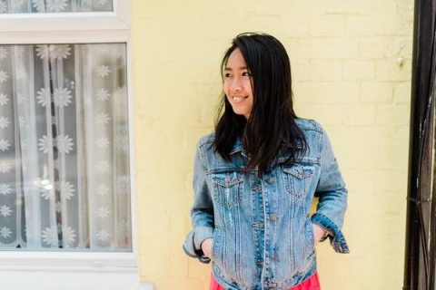 picture of female student in front of yellow wall
