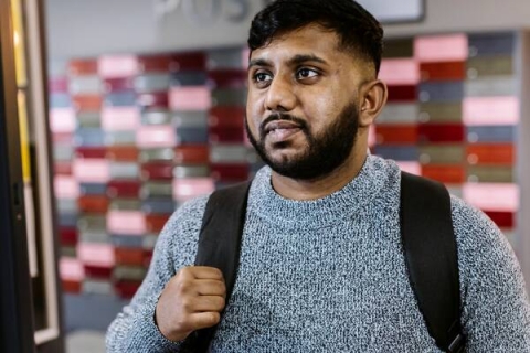 student standing in student accommodation lobby