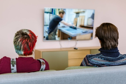 Two students watching television