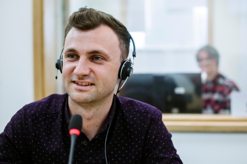 man with a headset speaking into a mic