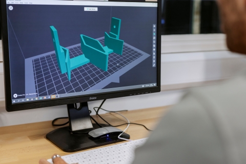 Staff member setting up 3D printer on display.
Technology Facilities Day One