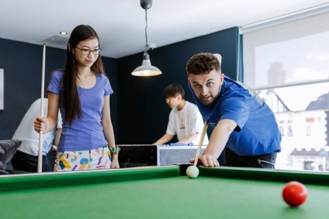 two students playing pool