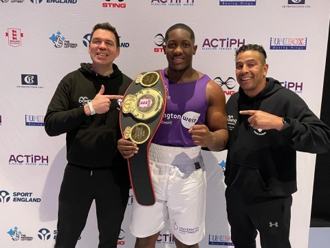 Derrick Osadolor holding National Champion belt